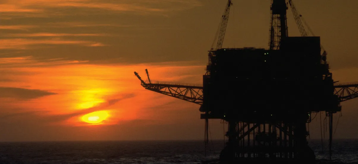 Offshore platform silhouetted at sunset