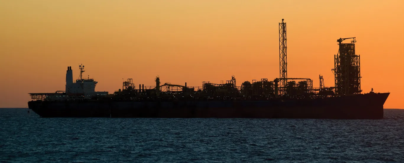 Late-life FPSO silhouetted at sunset